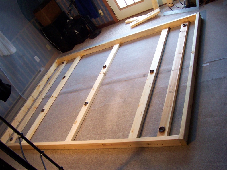 Lay two sections of wire mesh side by side underneath the wooden frame.JPG