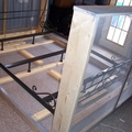 Place the bedframe on top of the wooden bottom frame