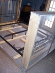 Place the bedframe on top of the wooden bottom frame